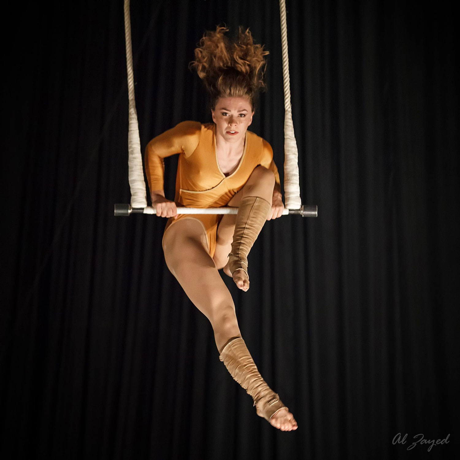 photo of Catherine Jett, NECCA Coach, performing on Trapeze