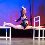 photo of Chloe Wailer performing a split at NECCA's Circus Spectacular in brattleboro vermont