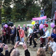 photo of a group of people shoveling in clown noses at the NECCA construction site