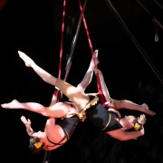 photo of the founders of NECCA performing a duo act on the trapeze