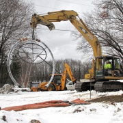 photo of the NECCA sign being raised at the new site