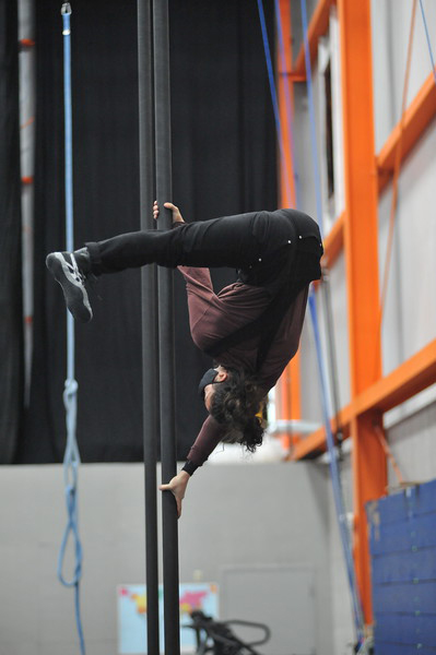 image of a chinese pole artist doing a handstand on the pole